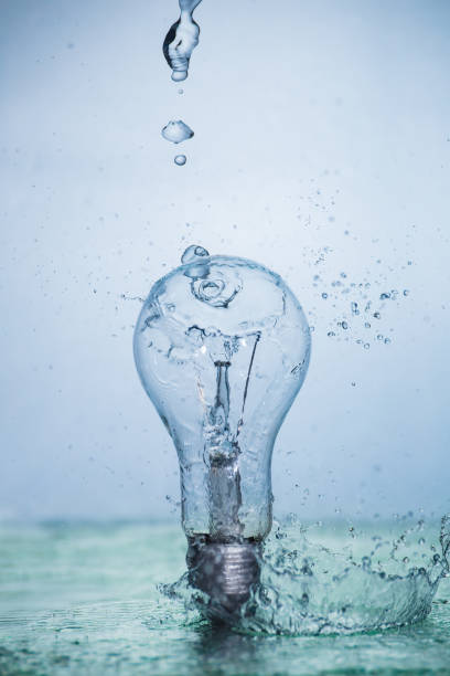 istock Bulb lamp with motion freezed water splashes. 1143284248