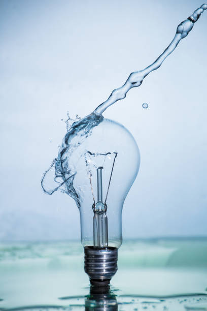 istock Bulb lamp with motion freezed water splashes. 1143284285