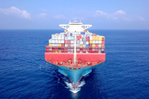 istock Large container ship at sea - Low angle aerial image. 1143284379