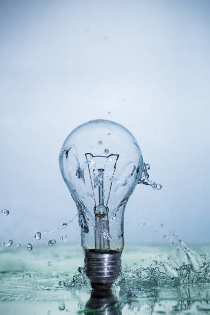 istock Bulb lamp with motion freezed water splashes. 1143284416