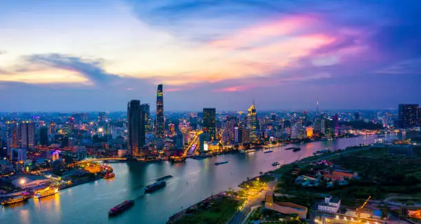 Aerial view of Ho Chi Minh City skyline and skyscrapers in center of heart business at Ho Chi Minh City downtown. Panorama of cityscape on Saigon river in Ho Chi Minh City at Vietnam at sunset scene