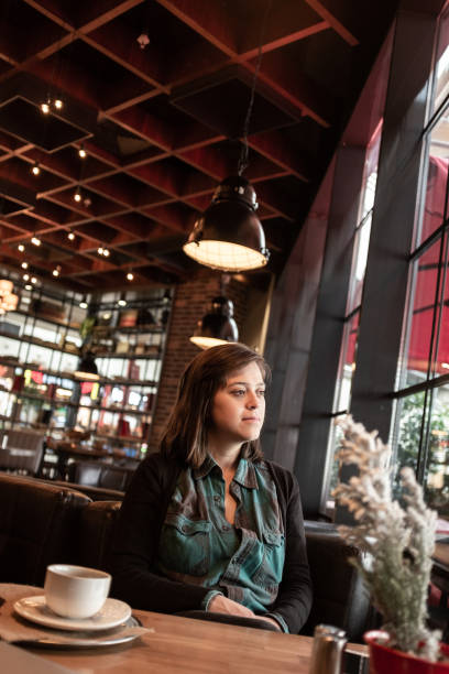 istock Happy Nice Lady Drinking Coffee in a Cafe 1143284983