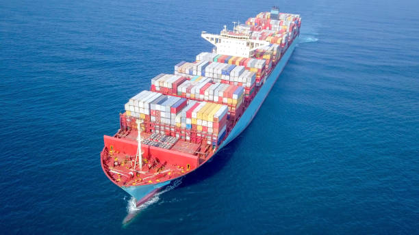 istock Large container ship at sea - Low angle aerial image. 1143284999