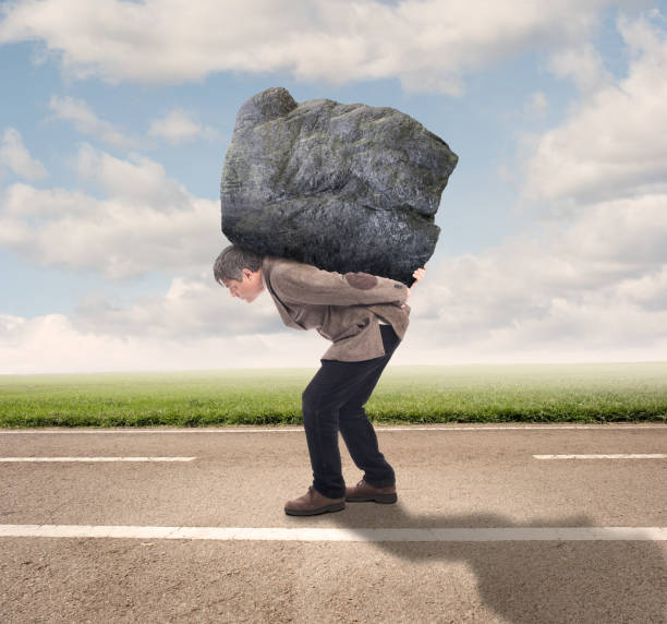 istock businessman holding a big rock 1143285690