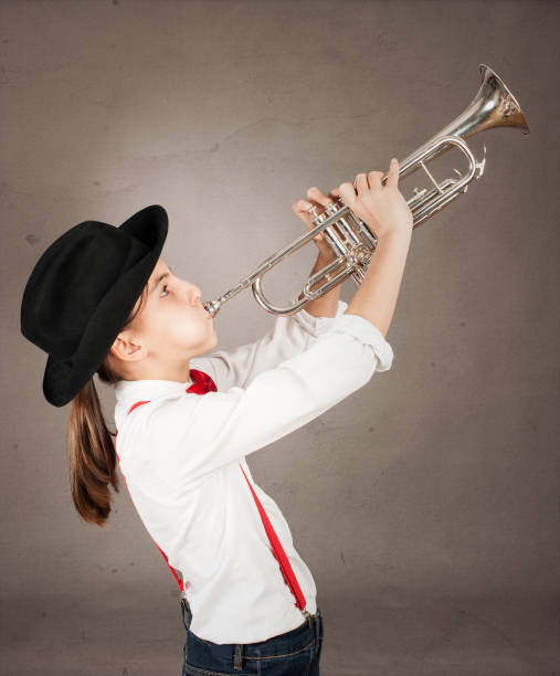 istock little girl playing trumpet 1143285696