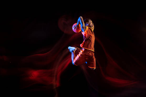 istock Young basketball player against dark background 1143285917