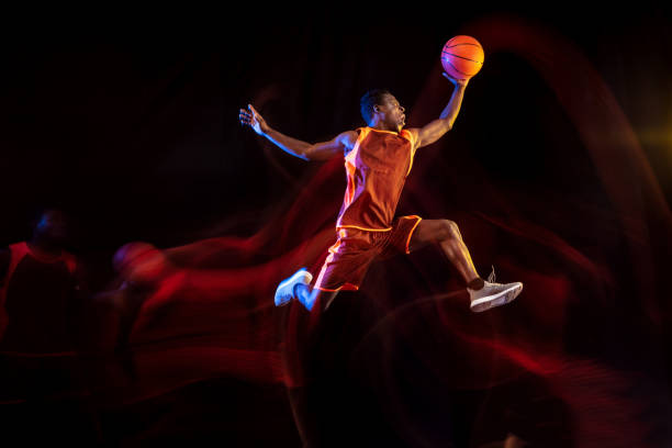 istock Young basketball player against dark background 1143285918