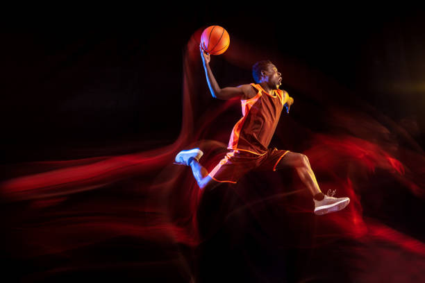 istock Young basketball player against dark background 1143285921