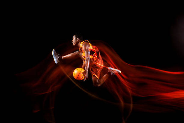 istock Young basketball player against dark background 1143285928