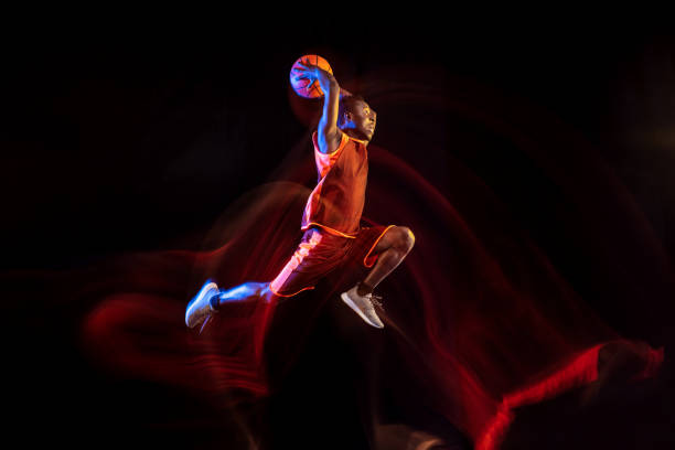 istock Young basketball player against dark background 1143285930