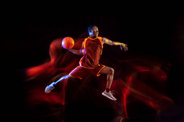 istock Young basketball player against dark background 1143285935