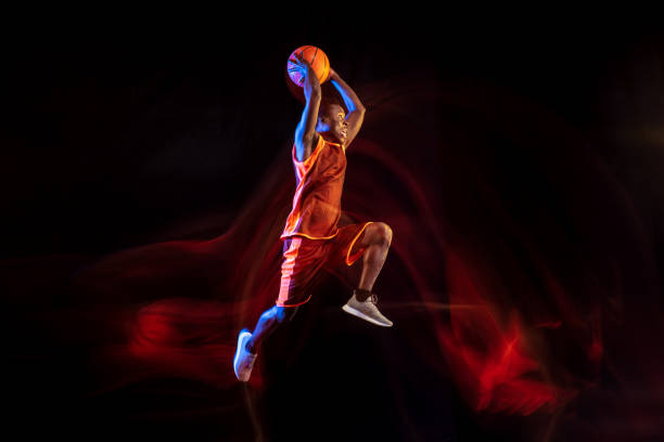 istock Young basketball player against dark background 1143285936