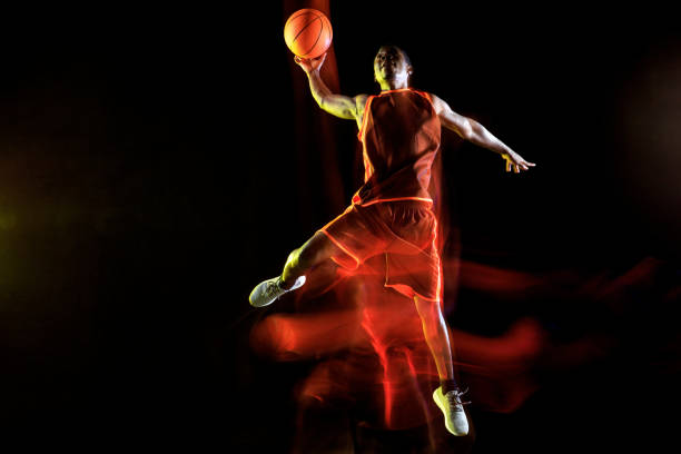 istock Young basketball player against dark background 1143285940