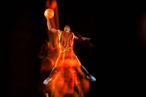 istock Young basketball player against dark background 1143285944