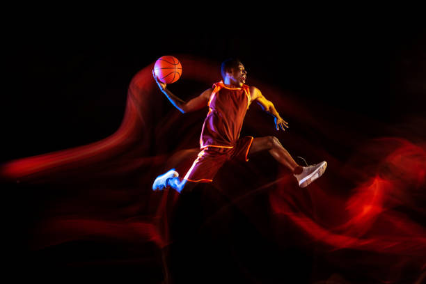 istock Young basketball player against dark background 1143285947