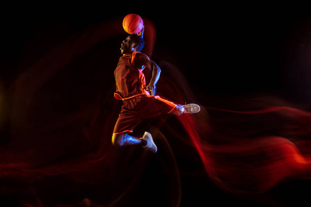 istock Young basketball player against dark background 1143285960