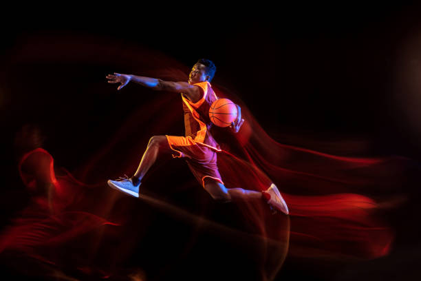 istock Young basketball player against dark background 1143285965