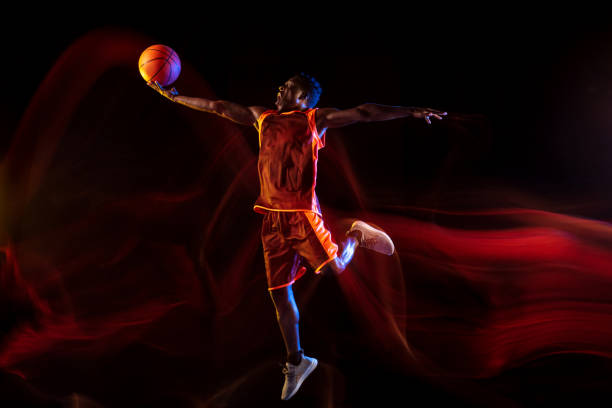 istock Young basketball player against dark background 1143285970