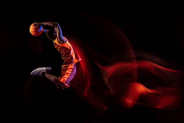 istock Young basketball player against dark background 1143285975