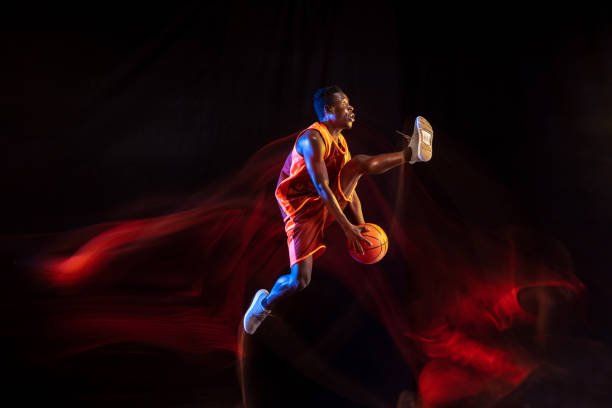 istock Young basketball player against dark background 1143285977