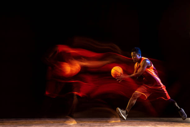 istock Young basketball player against dark background 1143285982