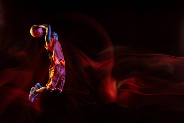 istock Young basketball player against dark background 1143285984