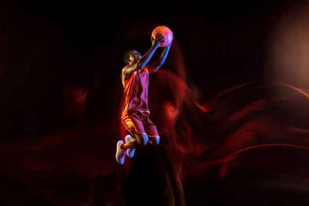 istock Young basketball player against dark background 1143285992