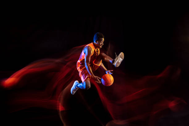 istock Young basketball player against dark background 1143285995