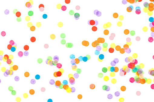 Bright multicolored confetti isolated on a white background. Festive concept. Children's party, birthday, wedding, celebration. Top view. Copy space.