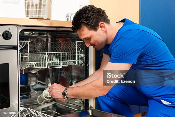 Technician Repairing A Dishwasher Stock Photo - Download Image Now - Repairing, Dishwasher, Industry