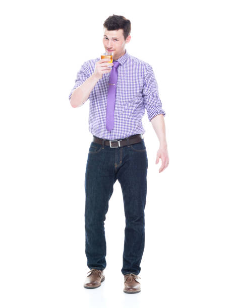 istock Attractive man standing and holding wisky drink 1143289547