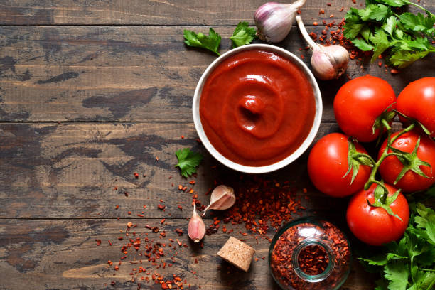 istock Tomato ketchup sauce with spices and pepper. View from above. 1143289869