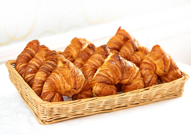 French fresh croissant in basket stock photo