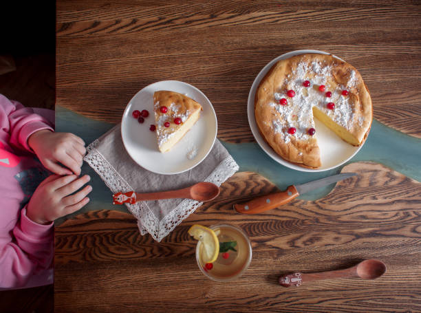 istock Children breakfast with Cheesecake with cranberries and sugar on wooden table 1143290923
