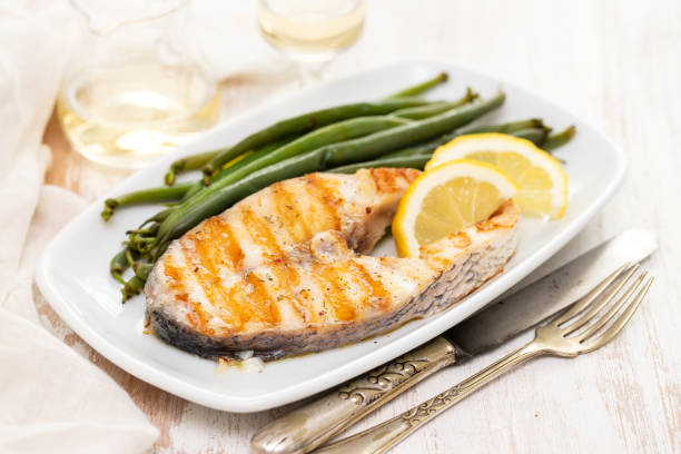 istock grilled perch with green beans and lemon on white dish 1143291003