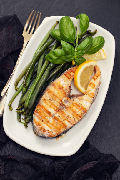 istock grilled perch with green beans and lemon on white dish 1143291006