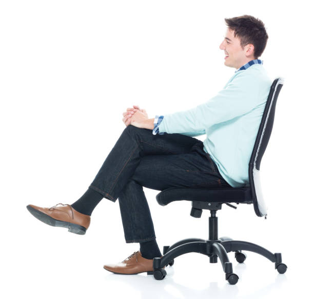 istock Handsome young man sitting and and being happy, side view 1143291163