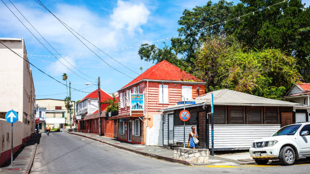 Bequia, Saint Vincent and the Grenadines: traditional Caribbean vernacular architecture - eaves and porch with gingerbread fretwork. The decorative wooden eaves and trim featuring intricate cutout patterns.