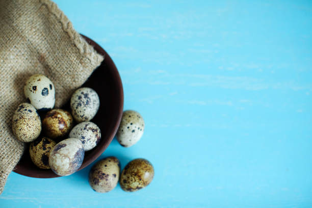 istock quail eggs on a blue old cracked board. village theme 1143292499