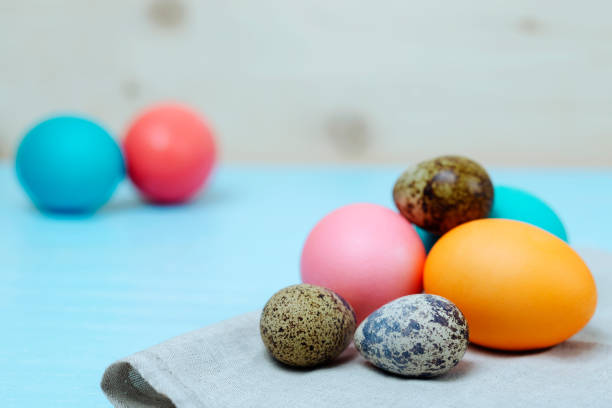 istock Easter painted chicken and quail eggs on a blue board. bright easter concept 1143292510