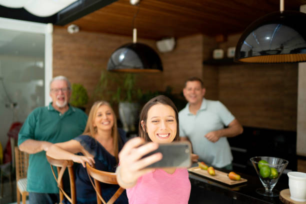 istock Woman taking a selfie with friends 1143292698
