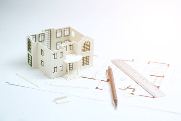 istock house model,blueprint,pencil and ruler on clean white background 1143293044