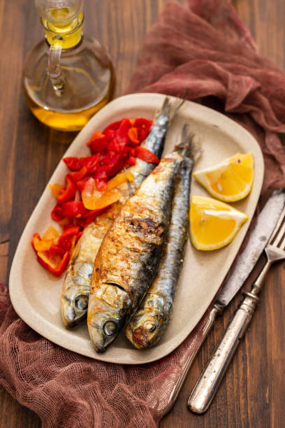 istock grilled sardines with red pepper and lemon on dish 1143293256