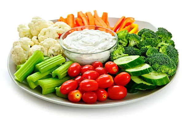 Photo of Fresh vegetables arranged on a platter with dip