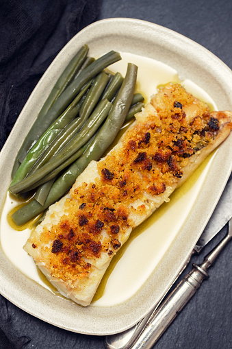 cod fish with corn bread and green beans on dish