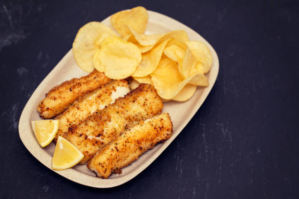 fried strips cuttlefish with potato on white dish