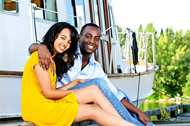 Photo of Happy couple in front of yacht