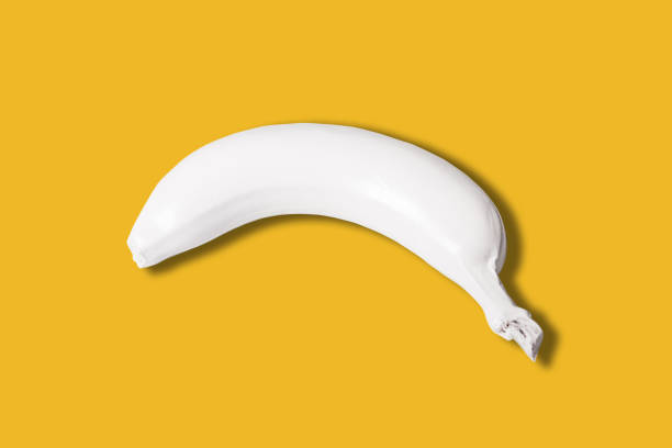 istock white colored banana isolated on yellow background 1143295677
