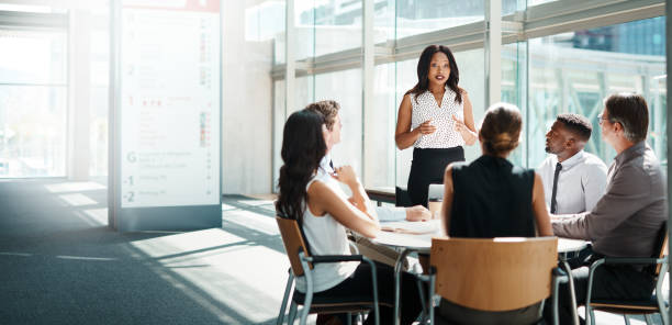Be the leader when all others are following Shot of a group of businesspeople having a meeting in a modern office colleague photos stock pictures, royalty-free photos & images