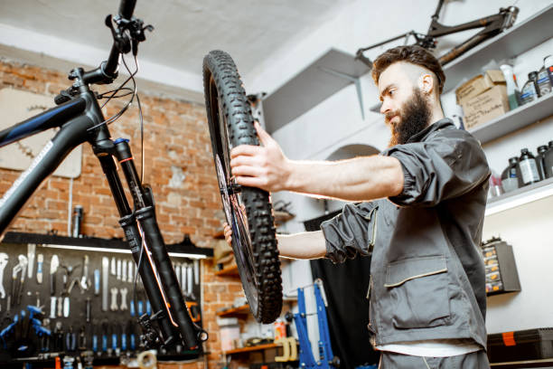 istock Repairman serving bicycle at the workshop 1143297791